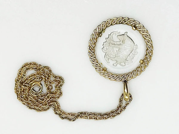 Experience the timeless style and celestial charm of the Trifari zodiac collection with our stunning Taurus pendant. Crafted with intricate details and high-quality materials, this clear glass pendant features a beautifully carved bull design bordered by a lustrous gold tone metal ribbon.