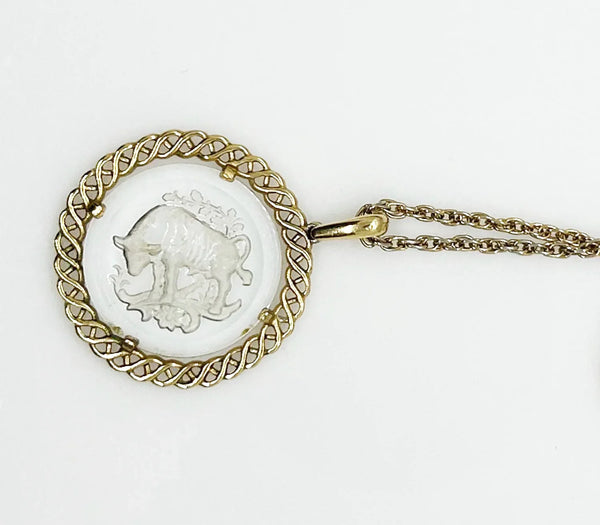 Experience the timeless style and celestial charm of the Trifari zodiac collection with our stunning Taurus pendant. Crafted with intricate details and high-quality materials, this clear glass pendant features a beautifully carved bull design bordered by a lustrous gold tone metal ribbon.