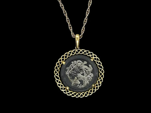 Experience the timeless style and celestial charm of the Trifari zodiac collection with our stunning Taurus pendant. Crafted with intricate details and high-quality materials, this clear glass pendant features a beautifully carved bull design bordered by a lustrous gold tone metal ribbon.