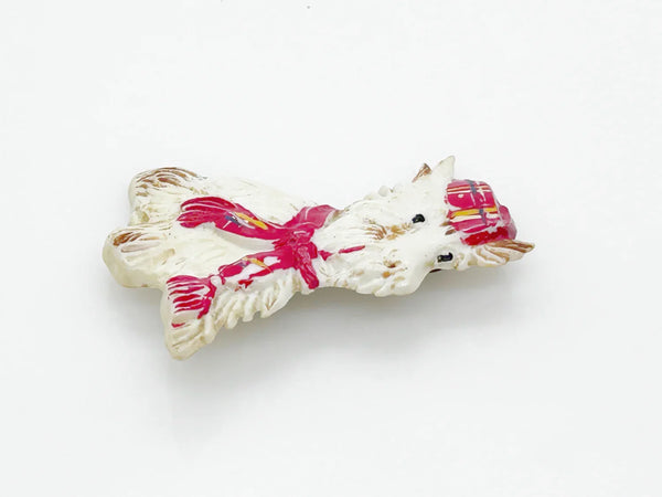Adorable mid-century white Scottish Terrier brooch sporting a festive red plaid cap and scarf! This charming 1.75" x 1.5" plastic pup features cute brown accents on feet, ears, and face. 