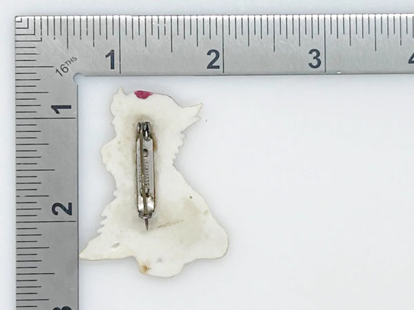 Adorable mid-century white Scottish Terrier brooch sporting a festive red plaid cap and scarf! This charming 1.75" x 1.5" plastic pup features cute brown accents on feet, ears, and face. 