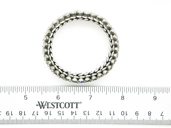 Sparkle up your vintage jewelry collection with this stunning three-row rhinestone bracelet expansion bracelet. Crafted in the classic style beloved from the 1940s through 1960s, this piece showcases brilliant clear glass rhinestones secured in a flexible silver-tone metal band. 