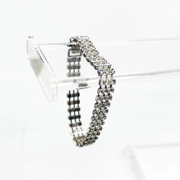 Perfect for vintage bracelet lovers: our Stunning Vintage Three Row Rhinestone Bracelet provides refined sophistication with bright stones and secure fit. Shop today!