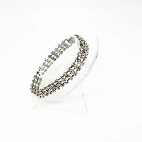 Perfect for vintage bracelet lovers: our Stunning Vintage Three Row Rhinestone Bracelet provides refined sophistication with bright stones and secure fit. Shop today!