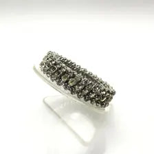 A close-up studio shot of a vintage silver-tone rhinestone expansion bracelet, featuring three rows of prong-set clear gemstones on a flexible, metallic accordion-style expansion band, shown against a plain white background
