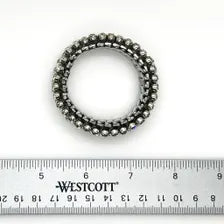 A close-up studio shot of a vintage silver-tone rhinestone expansion bracelet, featuring three rows of prong-set clear gemstones on a flexible, metallic accordion-style expansion band, shown against a plain white background