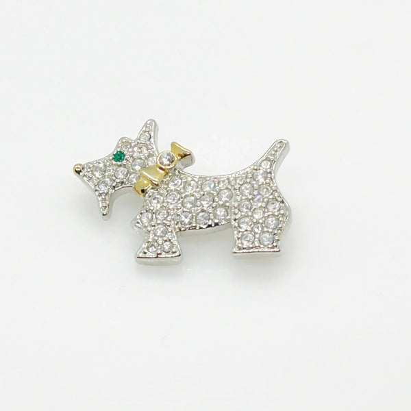 This brooch may be small in size, but is big on sparkle. Add a dash of canine charm to your outfit with this adorable vintage terrier brooch! This pint-sized pup brings major bling factor with its dazzling coat of pave set white rhinestones that catch the light with every movement. With its cheerful green eye that seems to wink at admirers, this petite (1.5" across) pin brings personality to any ensemble.
