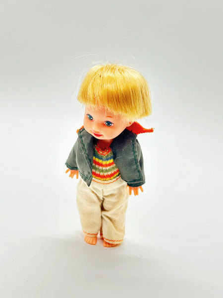 Vintage boy doll with blonde hair, rainbow sweater, and denim jacket, collector doll for vintage toy enthusiasts