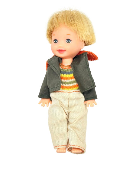 Vintage doll with blonde hair, rainbow sweater, and corduroy pants