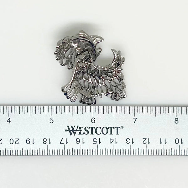 This adorable vintage Park Lane terrier brooch is on his way to more adventures (as terriers are). He has a head that moves and a sparkling green eye, his tail and ears are held high and so is his head.