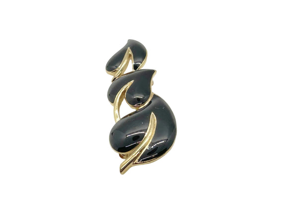 Meet your new favorite accessory! This gorgeous Trifari brooch showcases three beautifully crafted black enamel leaves accented with warm gold-tone metal—a timeless design from the 1980s-1990s era.