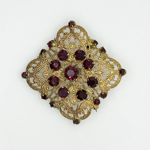 Intricate Vintage Gold Tone Brooch with Ruby Red Stones