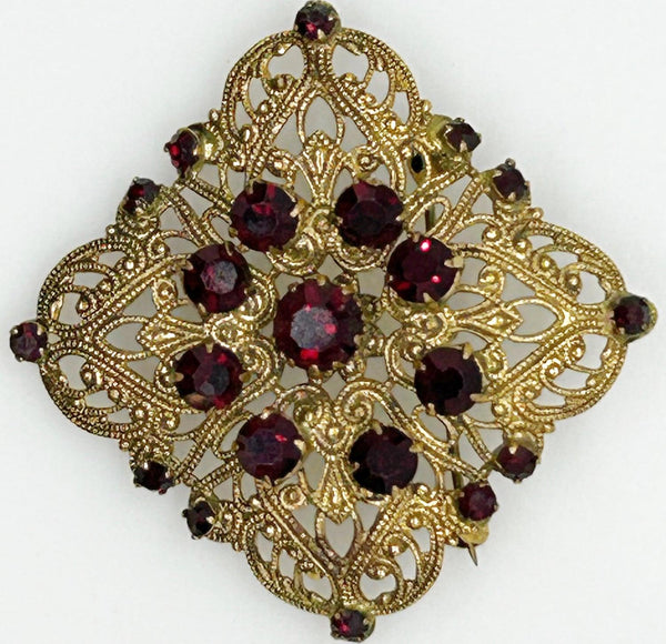 Intricate Vintage Gold Tone Brooch with Ruby Red Stones