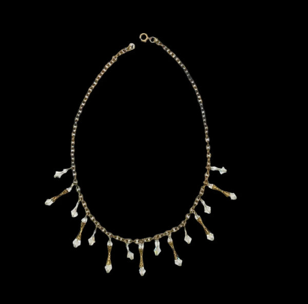 The delicate metal chain and shimmering aurora borealis beads will add a touch of glamour to any outfit. With a length of 17 inches and secure spring clasp, it's the perfect accessory for any occasion.