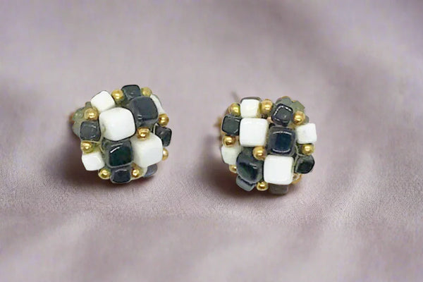 These stunning earrings beautifully blend retro charm with a contemporary edge. Each pair features hand-wired and meticulously strung black and white square beads, artfully accented with delicate tiny gold beads