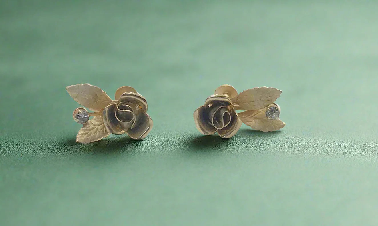 Elevate your look with vintage rose earrings featuring a detailed golden rose and rhinestone. Secure screw-back ensures comfort. Perfect rose bloom earrings.