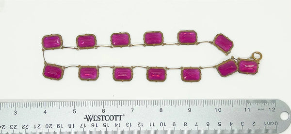 Admire the timeless beauty of our Graceful Vintage Czech Violet Clear Stones Necklace. Handcrafted with thirteen emerald cut purple clear stones encased in intricately detailed frames, this elegant necklace is a true work of art. With a length of approximately 15", it is a delicate and sophisticated addition to any outfit. Experience luxury and exclusivity with this exquisite piece, in immaculate condition.