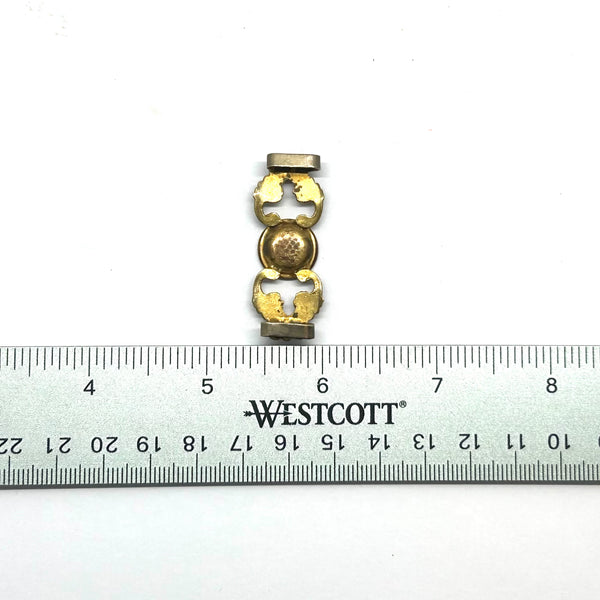 Antique Victorian monogrammed watch slide in gold-tone metal. Features a round hand-engraved monogram center and highly detailed repoussé scrollwork side accents, perfect as a jewelry making component