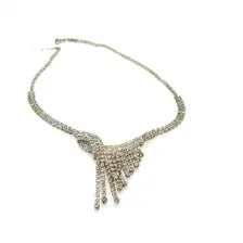A silver rhinestone necklace with a wide chain and a fan-shaped drop pendant, photographed on a plain white background.