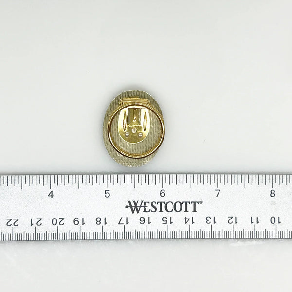 This exquisite scarf clip showcases delicate, finely crafted filigree work with layered, ruffled details resembling floral or ribbon motifs. Measuring 1.5" in length, it carries the distinguished signature of W. Germany, making it a unique and elegant accessory.