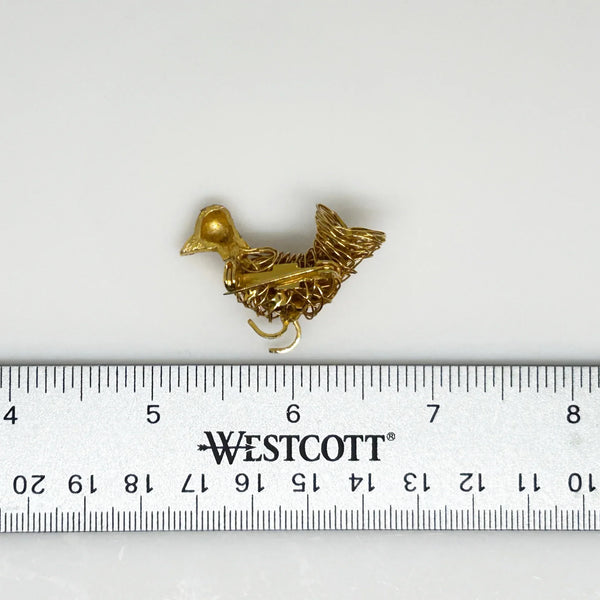 &nbsp;Sparkle and shine with this vintage bird brooch! Carefully crafted with gold tone wire, it features a delicate leaf wing and a textured head with a mesmerizing red eye. A true work of art that will add a touch of elegance to any outfit.