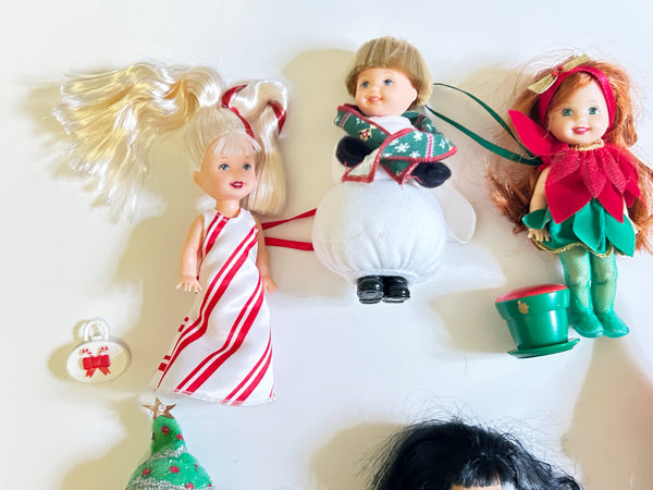 Lot of six loose vintage 2001 Mattel Barbie Kelly Club Christmas holiday ornament mini dolls against a white background, including Peppermint Kelly, Snowman Tommy, Poinsettia Jenny, Christmas Tree Chelsie, Santa Claus Tommy, and a doll in a red velvet dress