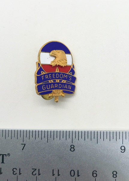 Vintage US Army FORSCOM Freedom's Guardian unit crest lapel pin featuring a gold-tone bald eagle against a red, white, and blue enameled background on a white backdrop