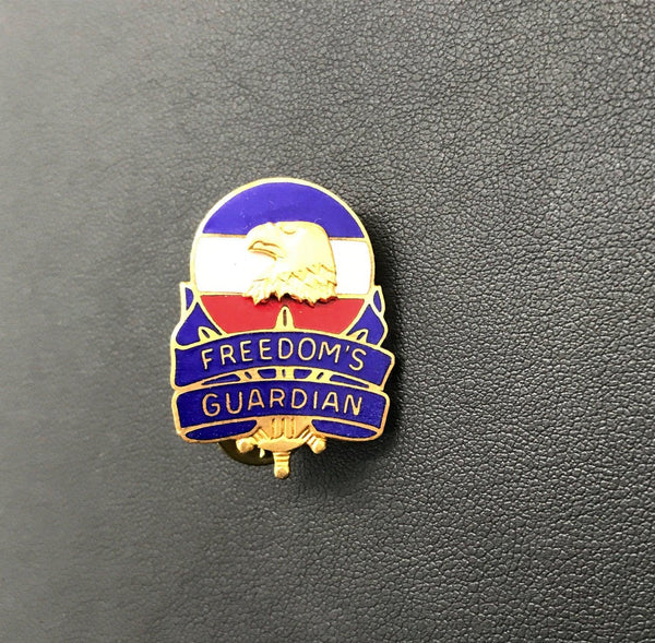 Vintage US Army FORSCOM Freedom's Guardian unit crest lapel pin featuring a gold-tone bald eagle against a red, white, and blue enameled background on a white backdrop