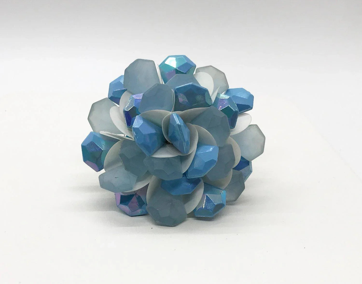 Elevate your accessory collection with this Vintage Layered Blue Petals Floral Brooch. Expertly crafted, it features a stunning arrangement of frosty blue beads delicately layered with soft white petals, creating a captivating floral design. At 2 1/2" in diameter, it makes a bold yet elegant statement.i